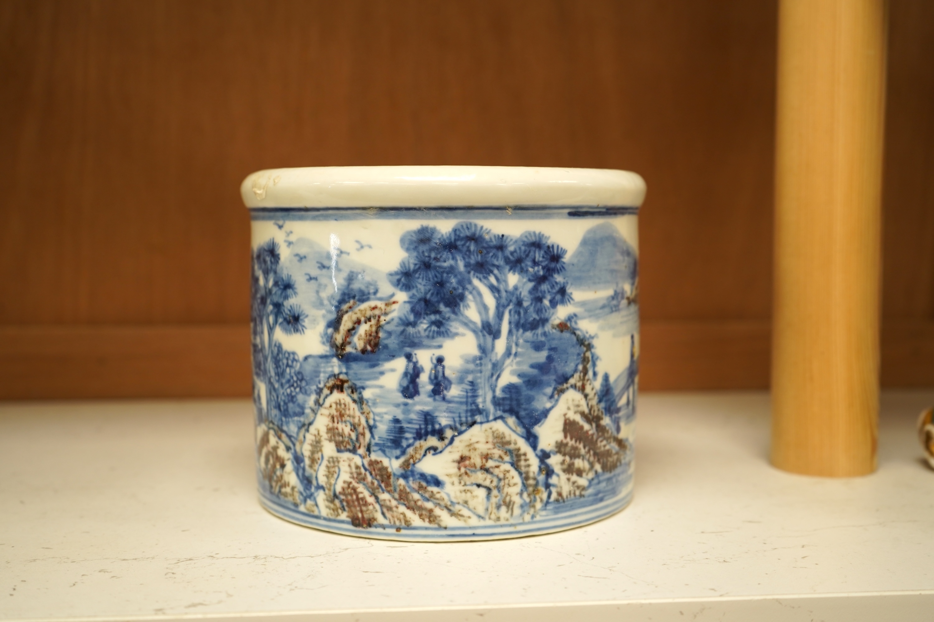 A Chinese blue and white with iron red cylindrical brush pot, 15cm in diameter